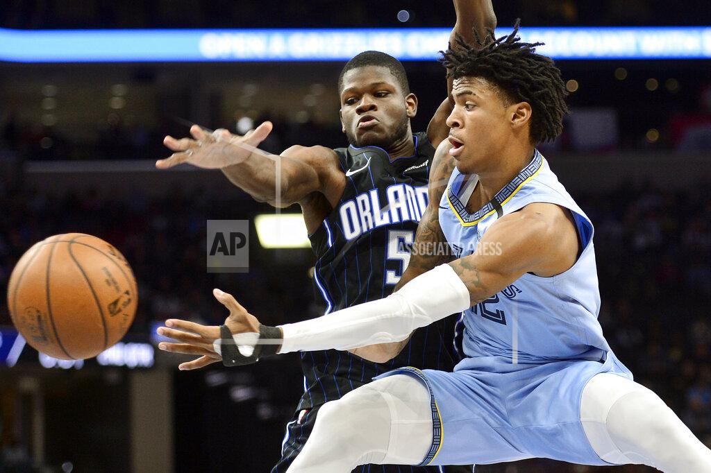 Brandon Dill FILE - In this March 10, 2020, file photo, Memphis Grizzlies guard Ja Morant, right, passes the ball as Orlando Magic center Mo Bamba (5) defends during the first half of an NBA basketball game in Memphis, Tenn. Morant has taken advantage of the NBA's hiatus, adding 12 pounds of muscle to help absorb contact when the NBA's likely rookie of the year fearlessly attacks the basketball. (AP Photo/Brandon Dill, File)