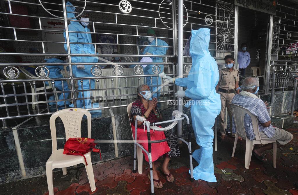 Rafiq Maqbool A health worker screens an elderly woman for COVID_19 symptoms at a temple in Mumbai, India, Saturday, July 18, 2020. India crossed 1 million coronavirus cases on Friday, third only to the United States and Brazil, prompting concerns about its readiness to confront an inevitable surge that could overwhelm hospitals and test the country's feeble health care system. (AP Photo/Rafiq Maqbool)