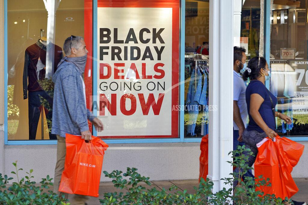 Chris O'meara Shoppers wear protective face masks as they look for Black Friday deals at the Ellenton Premium Outlet stores Friday, Nov. 27, 2020, in Ellenton, Fla. Attendance at the mall was down in an attempt to avoid spreading the corona virus. (AP Photo/Chris O'Meara)