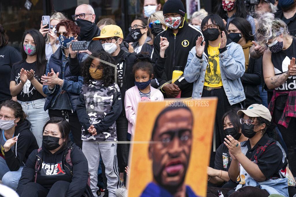 John Minchillo Demonstrators gather for a solidarity rally lead by community organizers in the Black and Asian communities in memory of George Floyd and Daunte Wright outside Cup Foods, Sunday, April 18, 2021, in Minneapolis. (AP Photo/John Minchillo)