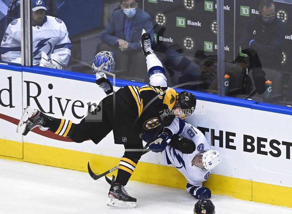 Nathan Denette Boston Bruins left wing Nick Ritchie (21) takes out Tampa Bay Lightning left wing Ondrej Palat (18) during the first period of an NHL hockey playoff game Wednesday, Aug. 5, 2020 in Toronto. (Nathan Denette/The Canadian Press via AP)