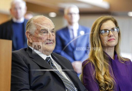 FILE - Philanthropist Walter Scott, left, sits next to Leslie Jackson, wife of glass artist Dale Chihuly during a ceremony at the Fred & Pamela Buffett Cancer Center in Omaha, Neb., Friday, May 19, 2017. Billionaire Scott, the past top executive of Peter Kiewit Sons Inc. construction firm who helped oversee Warren Buffett’s conglomerate and donated to various causes, particularly construction projects around Omaha, died, Saturday, Sept. 25, 2021. He was 90. (AP Photo/Nati Harnik, File)