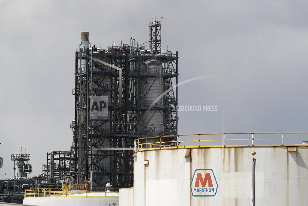 Paul Sancya FILE - In this April 21, 2020, file photo storage is shown at the Marathon Petroleum Corp. refinery in Detroit. Thousands of oil and gas operations, government facilities and other sites won permission to stop monitoring for hazardous emissions or otherwise bypass rules intended to protect health and the environment because of the coronavirus outbreak, The Associated Press has found. (AP Photo/Paul Sancya, File)