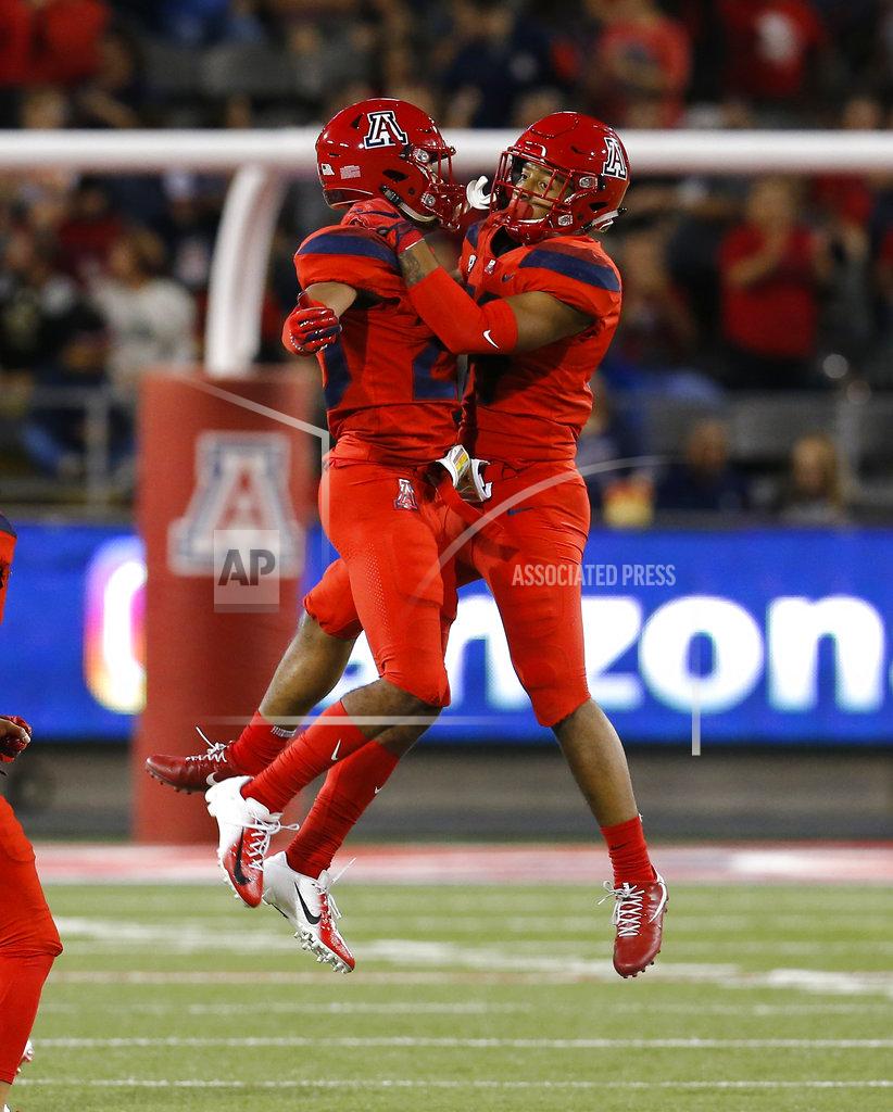 Rick Scuteri Arizona safety Scottie Young Jr., right, celebrates with Malik Hausman (23) after intercepting a pass in the first half during an NCAA college football game against Oregon, Saturday, Oct. 27, 2018, in Tucson, Ariz. (AP Photo/Rick Scuteri)