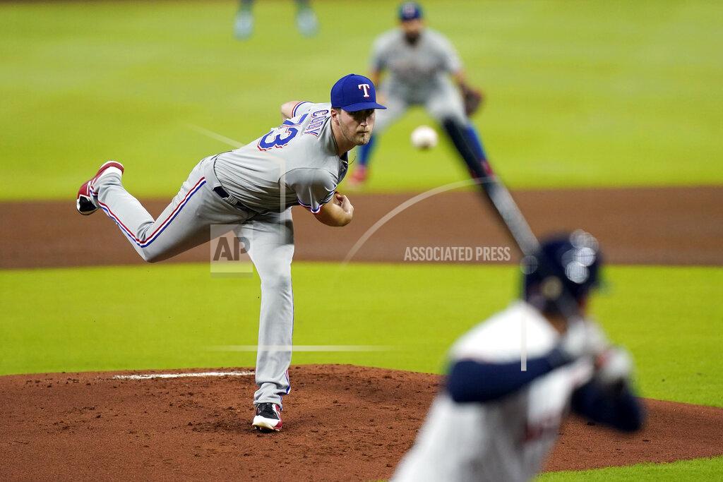 David J. Phillip Texas Rangers starting pitcher Kyle Cody, left, throws to Houston Astros' George Springer during the first inning of a baseball game Tuesday, Sept. 15, 2020, in Houston. (AP Photo/David J. Phillip)