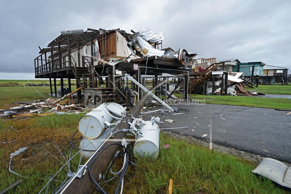 Gerald Herbert Storm clouds from approaching Tropical Storm Nicholas are seen behind homes destroyed by Hurricane Ida, in Pointe-aux-Chenes, La., Tuesday, Sept. 14, 2021. (AP Photo/Gerald Herbert)