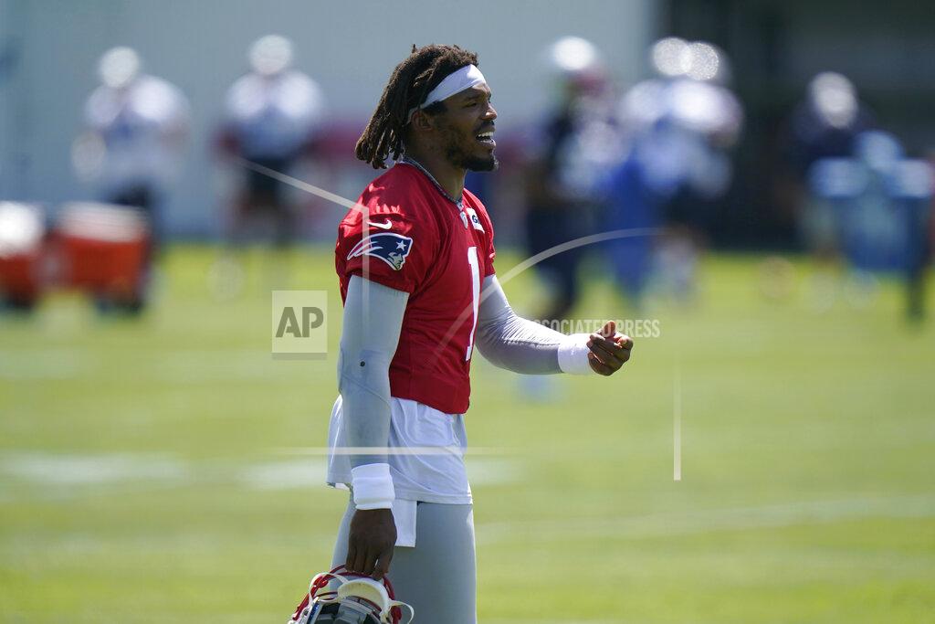 Steven Senne New England Patriots quarterback Cam Newton (1) carries his helmet on the field during an NFL football practice in Foxborough, Mass., Thursday, May 27, 2021. (AP Photo/Steven Senne)