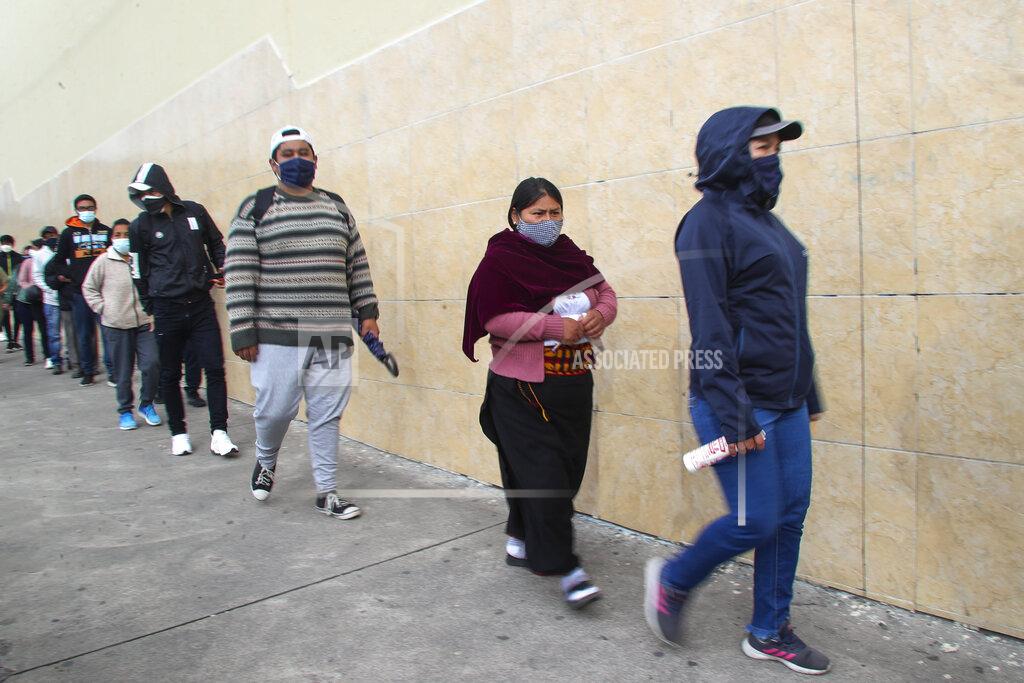 Dolores Ochoa Voters wearing masks to curb the spread of the COVID-19 line up at a polling station during runoff presidential election in Quito, Ecuador, Sunday, April 11, 2021. Ecuadorians are voting to choose between Andres Arauz, from the Union of Hope coalition, an economist protégé of former President Rafael Correa, and former banker Guillermo Lasso, of Creating Opportunities party, or CREO. (AP Photo/Dolores Ochoa)