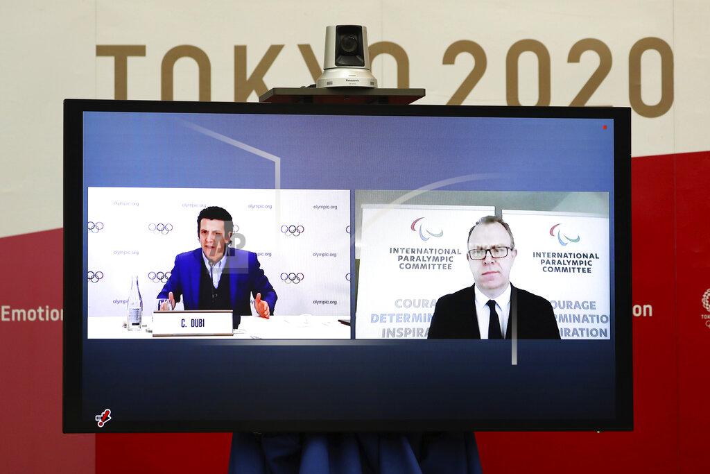 Du Xiaoyi Christophe Dubi, Olympic Games Executive Director for the International Olympic Committee (IOC), left, and Craig Spence, Chief Brand and Communications Officer for the International Paralympic Committee (IPC), join other representatives from the Tokyo Organizing Committee of the Olympic and Paralympic Games (Tokyo 2020) at a Joint press briefing in Tokyo on Wednesday, Feb. 3, 2021. Tokyo 2020, IOC and IPC announced Wednesday they jointly developed and published the first version of "The Playbooks," which contains advice from international and Japanese health experts for COVID-19 countermeasures as well as the guidelines and rules that each games stakeholder will need to observe in order to play their part in ensuing a safe and secure games. (Du Xiaoyi/Pool Photo via AP)
