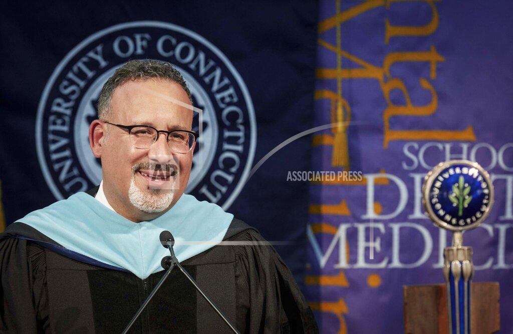 Peter Morenus This photo shows U.S. Secretary of Education Miguel Cardona as he delivers remarks, during a video recording address for University of Connecticut graduating students at Pratt & Whitney Stadium in East Hartford, Conn., Friday May 7, 2021. (Peter Morenus/UConn Photo via AP)