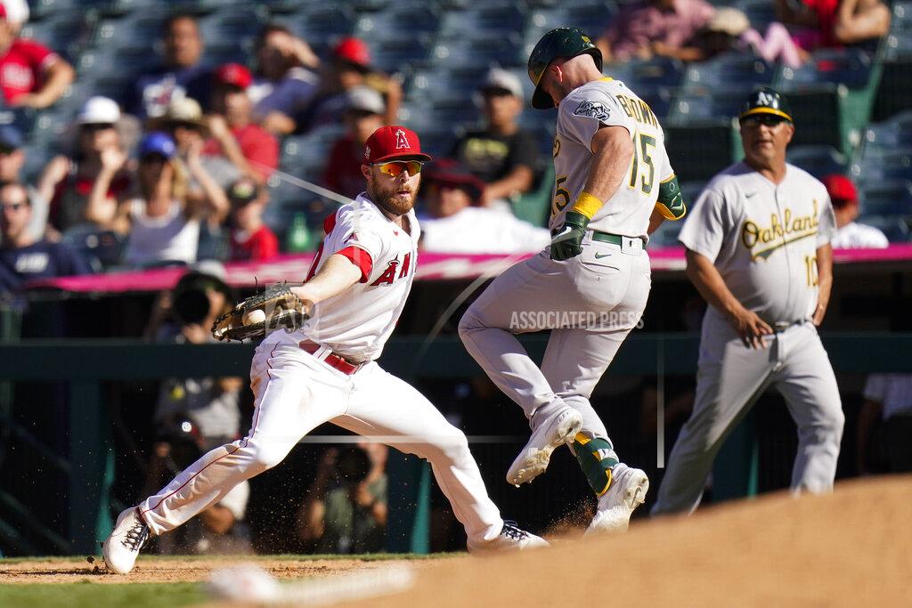 Jae C. Hong Oakland Athletics' Seth Brown, center, safely takes first base as Los Angeles Angels first baseman Jared Walsh, left, fields a throw during the 10th inning of a baseball game Sunday, Sept. 19, 2021, in Anaheim, Calif. (AP Photo/Jae C. Hong)