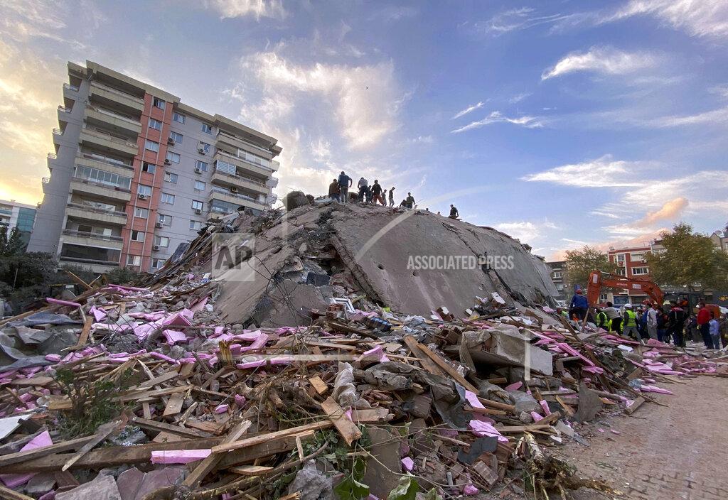 Ismail Gokmen Rescue workers try to save people trapped in the debris of a collapsed building, in Izmir, Turkey, Friday, Oct. 30, 2020. A strong earthquake struck Friday in the Aegean Sea between the Turkish coast and the Greek island of Samos, killing several people and injuring hundreds amid collapsed buildings and flooding, officials said.(AP Photo/Ismail Gokmen)