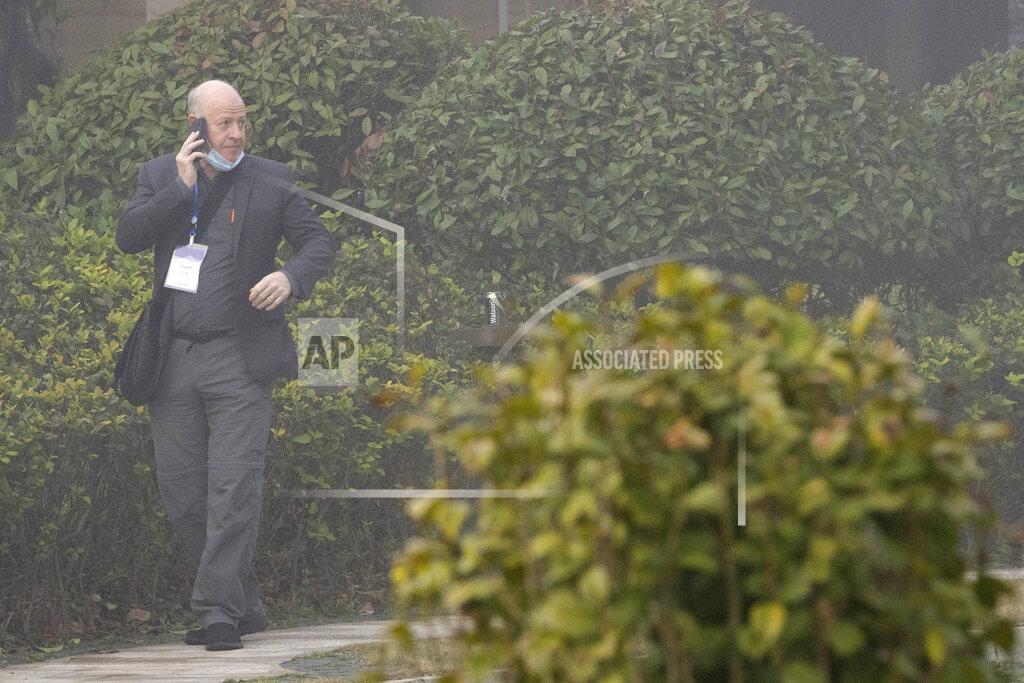 Ng Han Guan Peter Daszak makes a call on a foggy day before leaving his hotel with other members of a World Health Organization team for another day of field visit in Wuhan in central China's Hubei province Wednesday, Feb. 3, 2021. The WHO team is investigating the origins of the coronavirus pandemic has visited two disease control centers in the province. (AP Photo/Ng Han Guan)