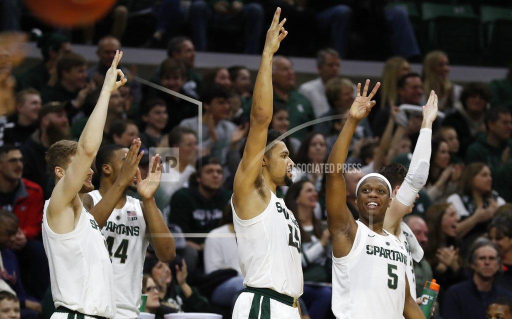 Carlos Osorio Michigan State forward Kyle Ahrens, left, forward Nick Ward (44), forward Kenny Goins (25) and guard Cassius Winston (5) react after a teammate's three-point basket during the second half of an NCAA college basketball game against Northern Illinois, Saturday, Dec. 29, 2018, in East Lansing, Mich. (AP Photo/Carlos Osorio)