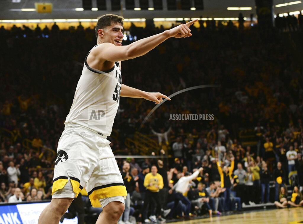 Cliff Jette Iowa's Luka Garza points to the bench after dunking the ball against Penn State during the second half of an NCAA college basketball game, Saturday, Feb. 29, 2020, in Iowa City, Iowa. (AP Photo/Cliff Jette)