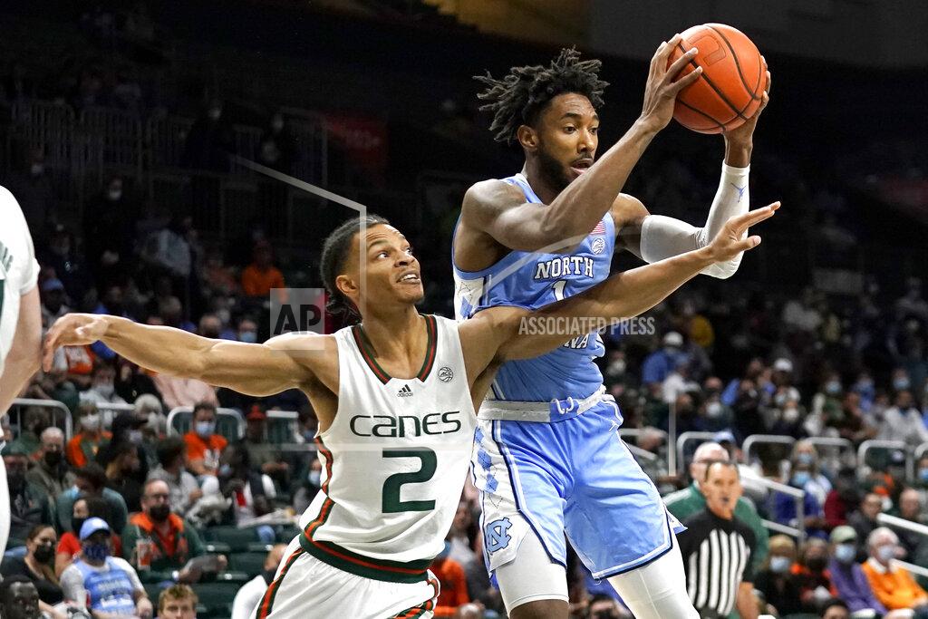 Lynne Sladky Miami guard Isaiah Wong (2) goes for a rebound against North Carolina guard Leaky Black, right, during the first half of an NCAA college basketball game, Tuesday, Jan. 18, 2022, in Coral Gables, Fla. (AP Photo/Lynne Sladky)