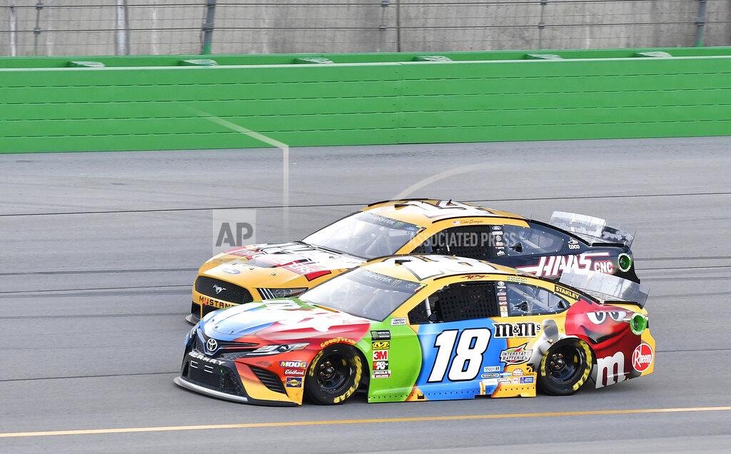 Timothy D. Easley Kyle Busch (18) tries to fight off the pass attempt from Clint Bowyer (14) during the NASCAR Cup Series auto race at Kentucky Speedway in Sparta, Ky., Saturday, July 13, 2019. (AP Photo/Timothy D. Easley)