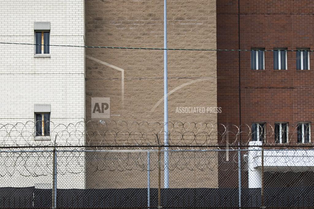FILE - This April 7, 2020 file photo shows barbed wire in front of the Cook County Jail and the Leighton Criminal Courthouse in Chicago. On Friday, May 8, 2020, The Associated Press reported on stories circulating online incorrectly asserting that there is plenty of room in Chicago’s jail after the city’s Mayor Lori Lightfoot, who threatened to arrest people for violating stay-at-home orders, released rapists from it. The mayor doesn’t have the power to release detainees or inmates from jail or prison, including the Cook County Jail in Chicago, which is run by county officials. Illinois Gov. J.B. Pritzker, a Democrat, signed an order in April allowing furloughs for elderly inmates because of COVID-19. Since then, the state’s prison population has declined by about 1,300 inmates. (Ashlee Rezin Garcia/Chicago Sun-Times via AP)