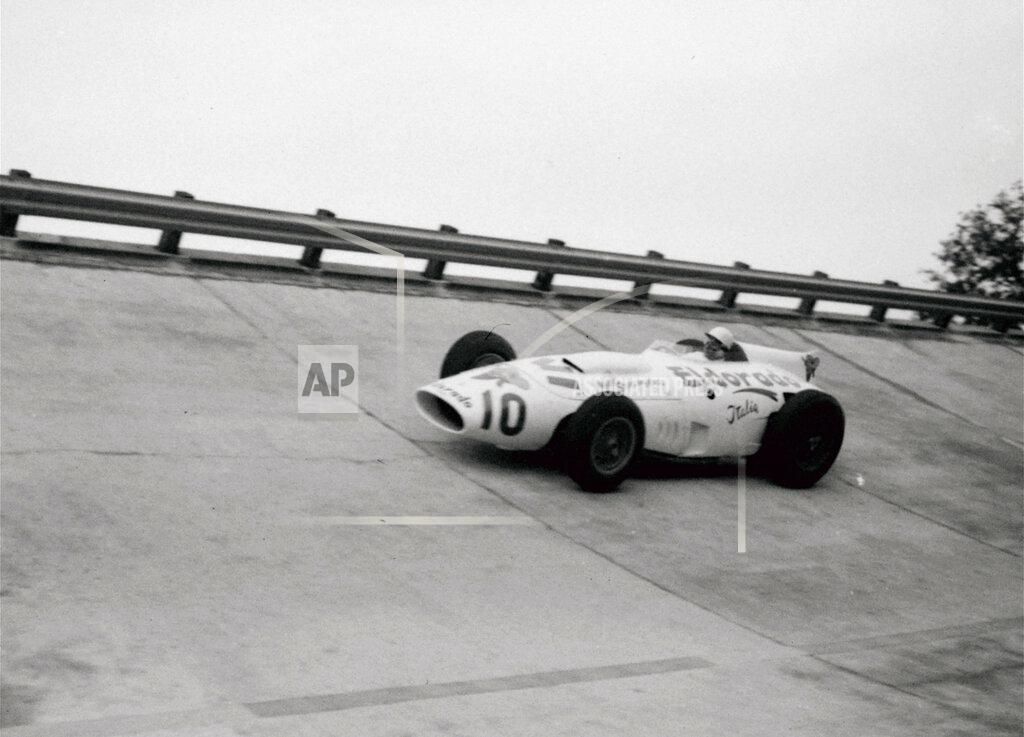 Uncredited FILE - In this file photo dated June 24, 1958, British racing driver Stirling Moss takes a curve on the Monza circuit in Italy, in the new Maserati Eldorado Special which he will drive in the forthcoming Monza 500. Stirling Moss has died at the age of 90, according to an announcement Sunday April 12, 2020, from his family.(AP Photo, FILE)