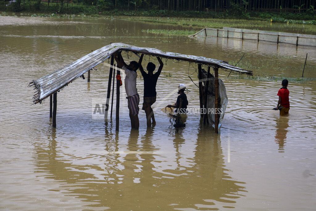 Shafiqur Rahman Rohingya refugees repair a shelter damaged following heavy rains at the Rohingya refugee camp in Kutupalong, Bangladesh, Wednesday, July 28, 2021. Days of heavy rains have brought thousands of shelters in various Rohingya refugee camps in Southern Bangladesh under water, rendering thousands of refugees homeless. (AP Photo/ Shafiqur Rahman)