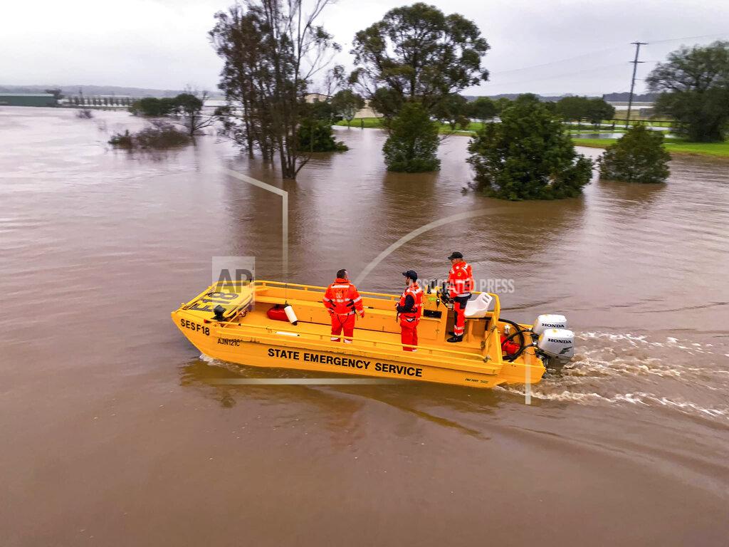 Uncredited In this photo provided by the State Emergency Service, a boat patrols the Hunter River near Hinton, Australia, Wednesday, July 6, 2022. Floodwaters were receding in Sydney and its surrounds on Thursday, July 7, 2022, as heavy rain continued to threaten to inundate towns north of Australia's largest city. (State Emergency Service via AP)