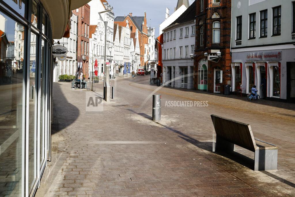 Frank Molter A street is deserted in the city center of Flensburg, Germany, Saturday, Feb. 20, 2021. Because of the high number of coronavirus infections in this northern German area, strickt measures take place in the city to avoid the further spread of the virus, including a curfew during the night from 21.00 in the evening until 5:00 in the morning. (Frank Molter/dpa via AP)