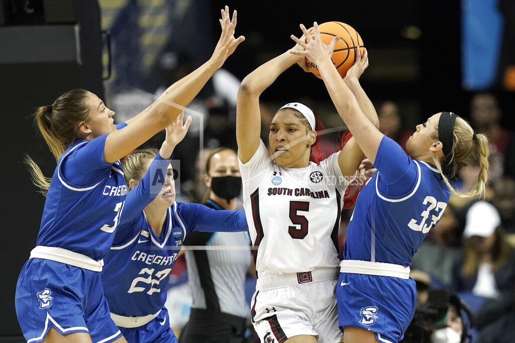 Gerry Broome South Carolina forward Victaria Saxton (5) looks to pass while Creighton forward Emma Ronsiek, left, guard Carly Bachelor (22) and guard Payton Brotzki (33) apply pressure during the first half of a college basketball game in the Elite 8 round of the NCAA tournament in Greensboro, N.C., Sunday, March 27, 2022. (AP Photo/Gerry Broome)