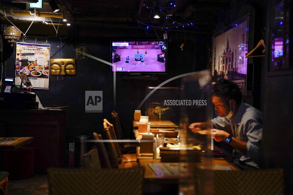 Jae C. Hong FILE - In this July 24, 2021, file photo, a diner eats his lunch in a restaurant as a TV shows a table tennis match between Japan and Austria at the 2020 Summer Olympics in Tokyo. (AP Photo/Jae C. Hong, File)