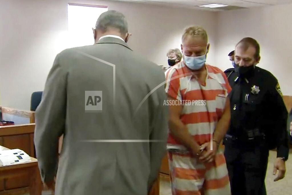 Uncredited In this still image from video, Barry Morphew, center, appears in court in Salida, Colo., Thursday, May 6, 2021. Morphew was arrested on Wednesday, May 5, in connection with the disappearance of his wife, Suzanne Morphew, who was last seen a year ago on Mother's Day, May 10, 2020. (KUSA via AP, Pool)