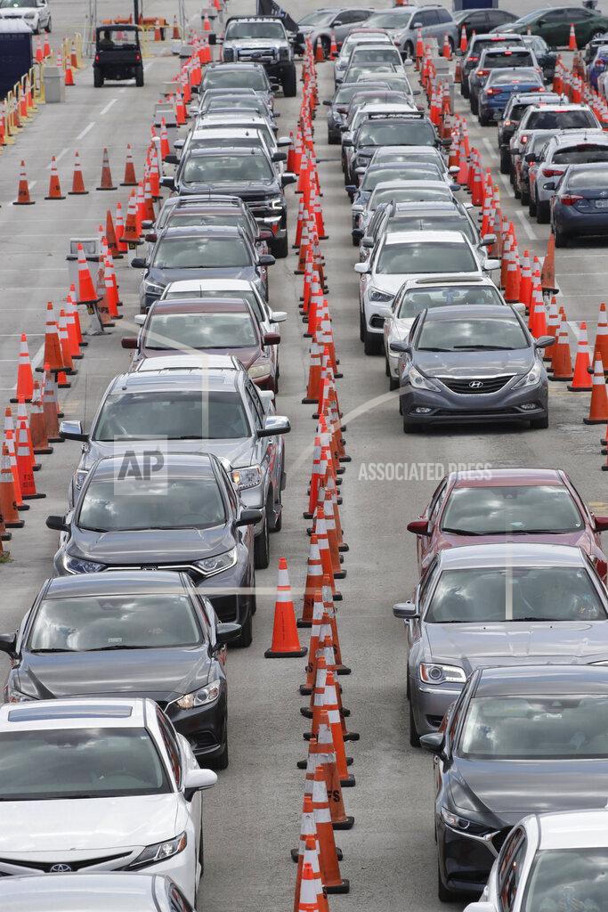 Wilfredo Lee FILE - Cars wait in line at a drive-through COVID-19 testing site outside Hard Rock Stadium, in a Wednesday, July 8, 2020 file photo, in Miami Gardens, Fla. Florida on Sunday, July 13, 2020 reported the largest single-day increase in positive coronavirus cases in any one state since the beginning of the pandemic. (AP Photo/Wilfredo Lee)