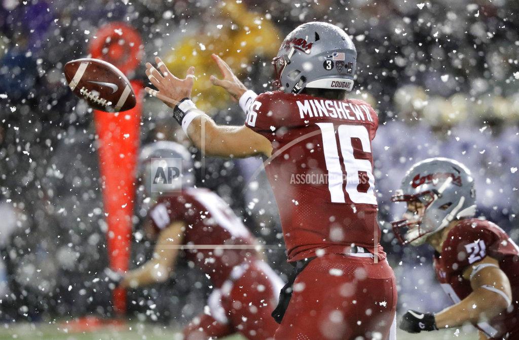 Ted S. Warren Washington State quarterback Gardner Minshew takes a snap as snow falls during the first half of an NCAA college football game against Washington, Friday, Nov. 23, 2018, in Pullman, Wash. (AP Photo/Ted S. Warren)
