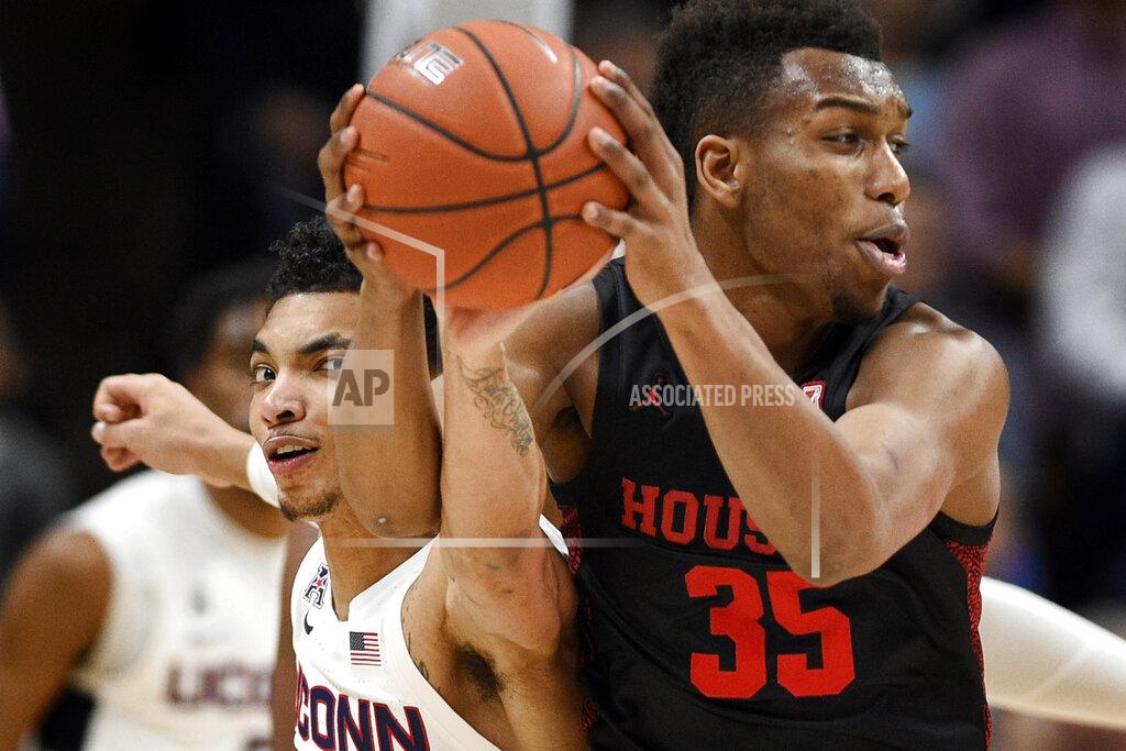 Jessica Hill Connecticut's James Bouknight, left, reaches in and pressures Houston's Fabian White Jr., right, in the first half of an NCAA college basketball game, Thursday, March 5, 2020, in Storrs, Conn. (AP Photo/Jessica Hill)