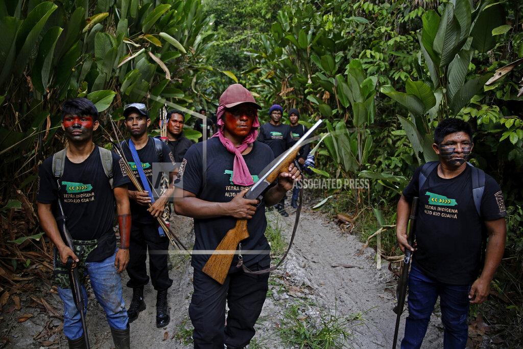 Eraldo Peres FILE - In this Sept. 8, 2020 file photo, Tenetehara Indigenous man Matuha Tembe, holds a shotgun as he patrols with the the Ka'Azar, or Forest Owners, on the Alto Rio Guama reserve in Para state, near the city of Paragominas, Brazil. President Jair Bolsonaro, a former Army captain who expresses nostalgia for Brazil’s three decades of military rule, has said he wants to arm citizens to prevent a dictatorship from taking hold. (AP Photo/Eraldo Peres, File)