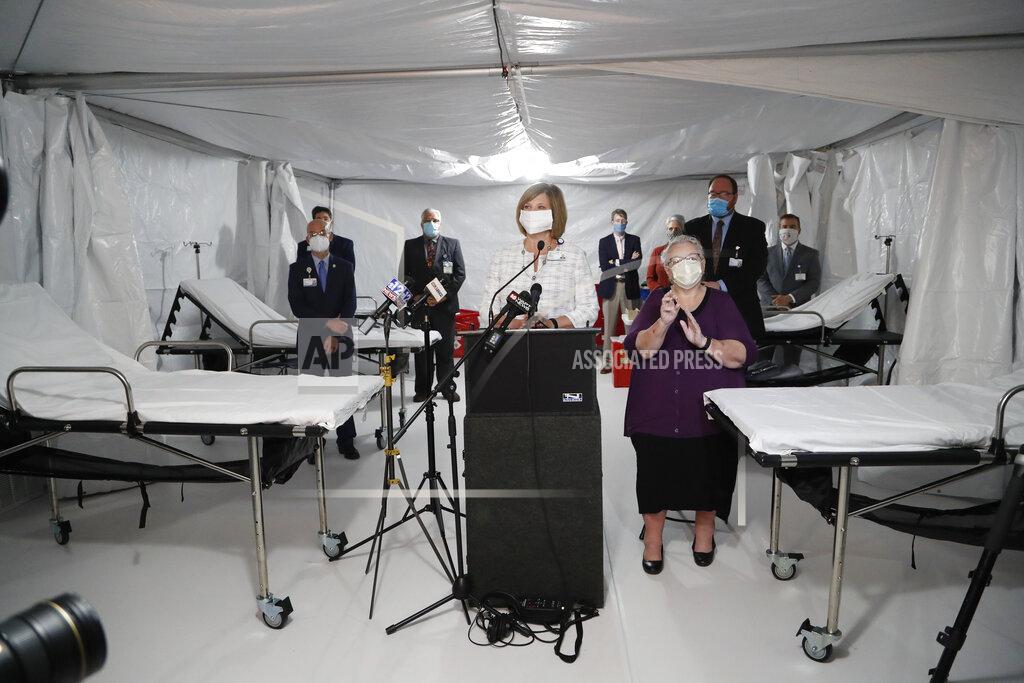 Rogelio V. Solis University of Mississippi Medical Center Vice Chancellor Dr. LouAnn Woodward, center, speaks of the need to establish a mobile field clinic in the basement of a parking lot at the facility, as staff prepare for more coronavirus cases, as department heads flank her, Wednesday, April 8, 2020 in Jackson, Miss. (AP Photo/Rogelio V. Solis)
