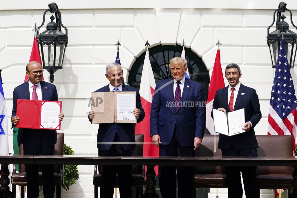 Alex Brandon President Donald Trump, center, with from left, Bahrain Foreign Minister Khalid bin Ahmed Al Khalifa, Israeli Prime Minister Benjamin Netanyahu, Trump, and United Arab Emirates Foreign Minister Abdullah bin Zayed al-Nahyan, during the Abraham Accords signing ceremony on the South Lawn of the White House, Tuesday, Sept. 15, 2020, in Washington. (AP Photo/Alex Brandon)