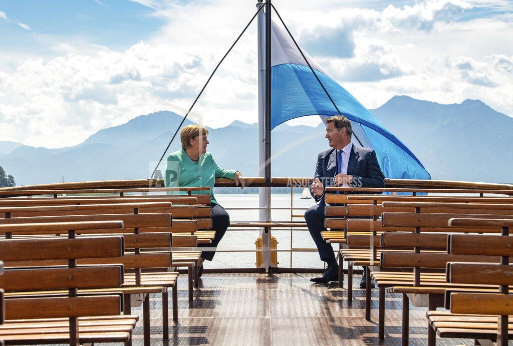 Peter Kneffel FILE - In this Tuesday, July 14, 2020 file photo, German Chancellor Angela, left, and Markus Soeder, right, Governour of the German state of Bavaria, talk during a boat tour in Priem Am Chiemsee, Germany. Markus Soeder is many things: state governor of Bavaria, Star Trek fan, a conservative for whom combating climate change is an article of faith. The question Germans are asking now is: can the 54-year-old win enough backing across the political spectrum to succeed Angela Merkel as chancellor in September. (Peter Kneffel/DPA via AP, Pool, file)