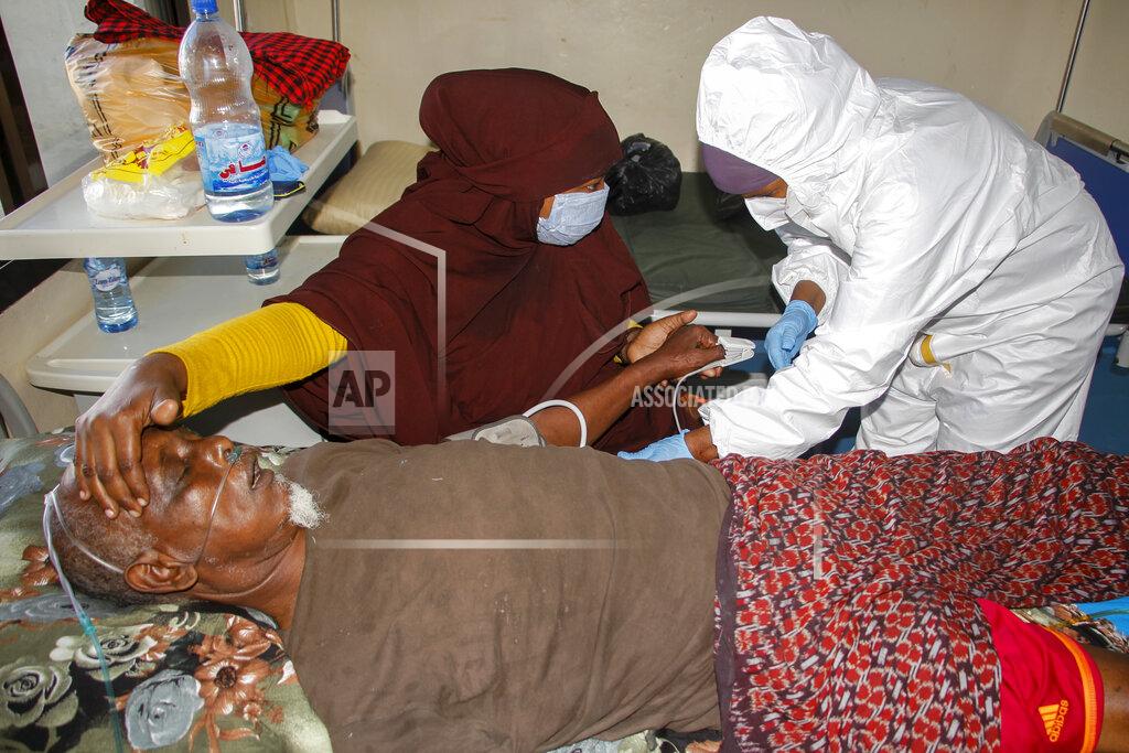 Farah Abdi Warsameh A doctor tends to a patient on oxygen suffering from COVID-19 in a ward for coronavirus patients at the Martini hospital in Mogadishu, Somalia on Wednesday, Feb. 24, 2021. A crisis over the supply of medical oxygen for coronavirus patients has struck in Africa and Latin America, where warnings went unheeded at the start of the pandemic and doctors say the shortage has led to unnecessary deaths. (AP Photo/Farah Abdi Warsameh)