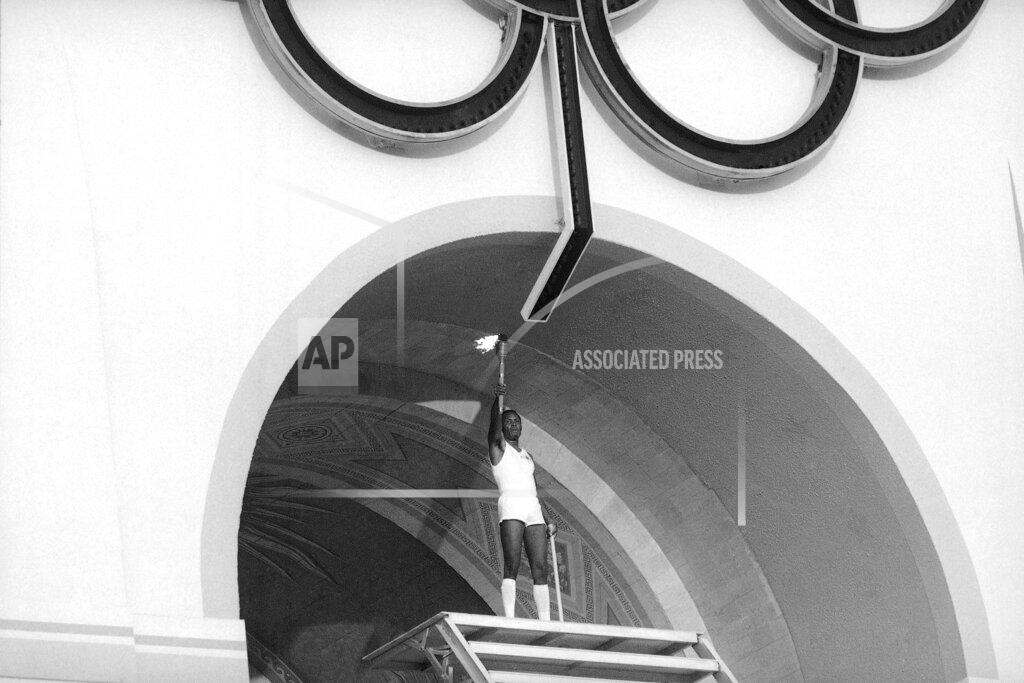 Anonymous Rafer Johnson, 1960 gold medalist for the decathlon, lights the Olympic torch during the Opening Ceremonies of the 23rd Olympiad in Los Angeles in 1984. (AP Photo)