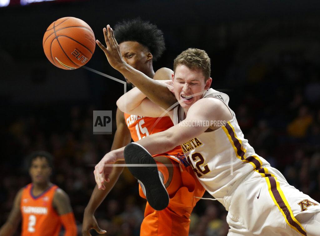 Andy Clayton-King Minnesota forward Michael Hurt (42) and Clemson forward John Newman III (15) battle for a rebound in the second half during an NCAA college basketball game Monday, Dec. 2, 2019, in Minneapolis. (AP Photo/Andy Clayton-King)