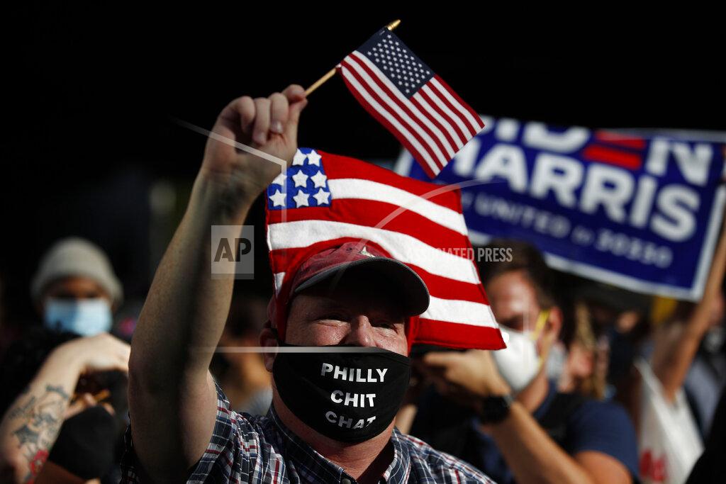 Rebecca Blackwell People celebrate outside the Pennsylvania Convention Center, Saturday, Nov. 7, 2020, in Philadelphia, after Democrat Joe Biden defeated President Donald Trump to become 46th president of the United States. (AP Photo/Rebecca Blackwell)