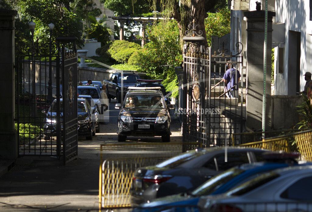 Federal police leave Laranjeiras Palace, the official residence of Rio de Janeiro Gov. Wilson Witzel, in Rio de Janeiro, Brazil, Tuesday, May 26, 2020. Brazil's Federal Police raided the governor's official residence on Tuesday to carry out searches, part of an investigation into the embezzlement of public resources in the state's response to the COVID-19 pandemic. (AP Photo/Silvia Izquierdo)