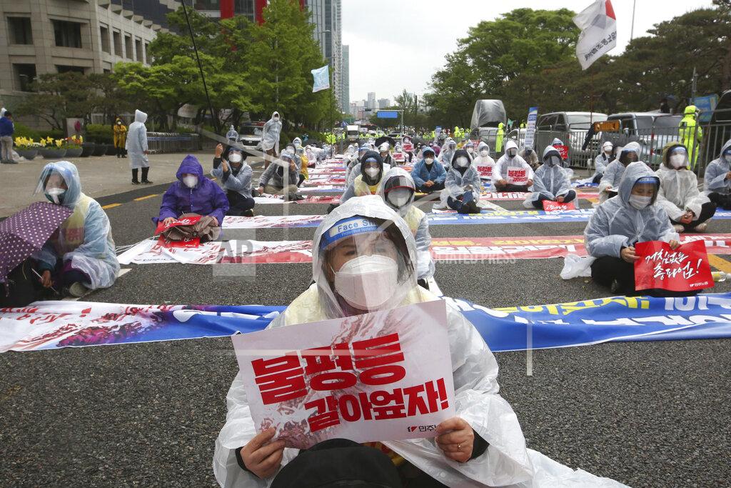 Ahn Young-Joon Members of the Korean Confederation of Trade Unions stage a May Day rally demanding better working conditions and expanding labor rights in Seoul, South Korea, Saturday, May 1, 2021. The signs read: "Let's solve inequality." (AP Photo/Ahn Young-joon)