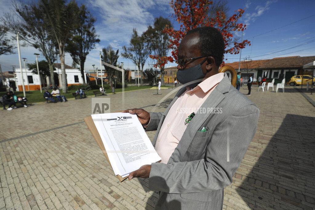 Fernando Vergara Community leader Baldoino Asprilla shows a death threat that was sent to him, during an interview in Bogota, Colombia, Thursday, Dec. 17, 2020. Last year 120 community leaders were murdered in Colombia according to the U.N.’s High Commissioner for Human Rights, up from 107 a year earlier. (AP Photo/Fernando Vergara)