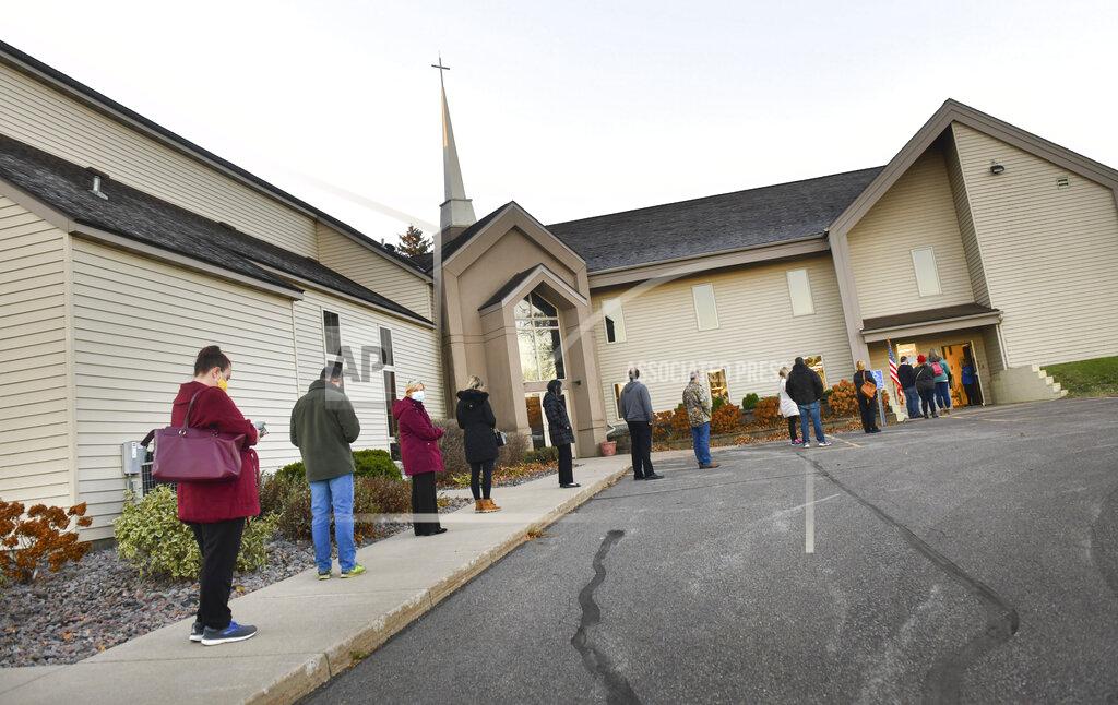 Dave Schwarz Voters stand in line about fifteen minutes after the polls opened at Messiah Lutheran Church, Tuesday, Nov. 3, 2020, in Sartell, Minn. (Dave Schwarz/St. Cloud Times via AP)