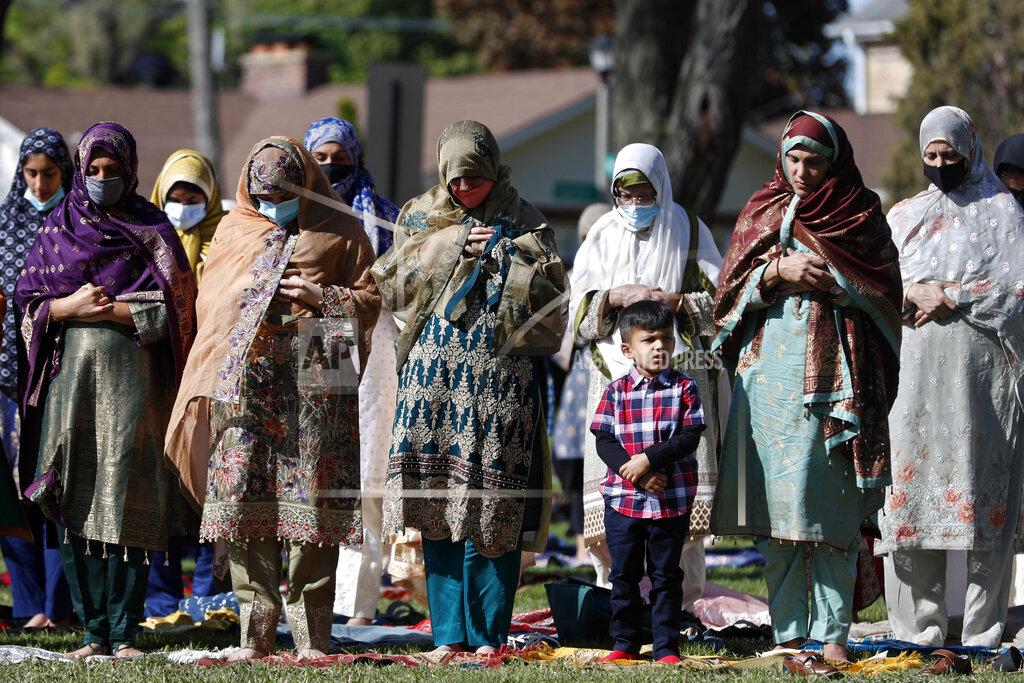 Shafkat Anowar Muslim women perform an Eid al-Fitr prayer in an outdoor open area, marking the end of the fasting month of Ramadan, Thursday, May 13, 2021 in Morton Grove, Ill. (AP Photo/Shafkat Anowar)