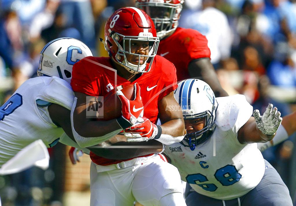 Butch Dill Alabama running back Josh Jacobs (8) carries the ball as he is tackled by Citadel linebacker Noah Dawkins (38) and defensive lineman Ken Allen (68) during the first half of an NCAA college football game, Saturday, Nov. 17, 2018, in Tuscaloosa, Ala. (AP Photo/Butch Dill)
