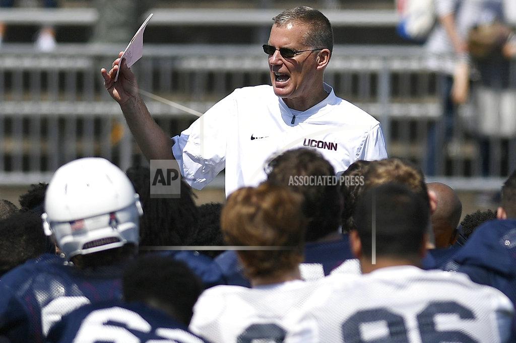 Jessica Hill FILE - In this April 14, 2018, file photo, head coach Randy Edsall talks with his team at the end of Connecticut's annual spring NCAA college football game in East Hartford, Conn. UConn will host Central Florida to open the regular season on Thursday, Aug. 30. (AP Photo/Jessica Hill)