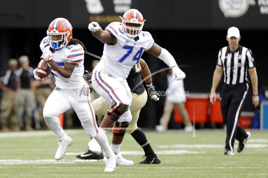 Mark Humphrey Florida running back Jordan Scarlett (25) carries the ball past offensive lineman Fred Johnson (74) as Scarlett runs 48-yards for a touchdown against Vanderbilt in the second half of an NCAA college football game Saturday, Oct. 13, 2018, in Nashville, Tenn. (AP Photo/Mark Humphrey)