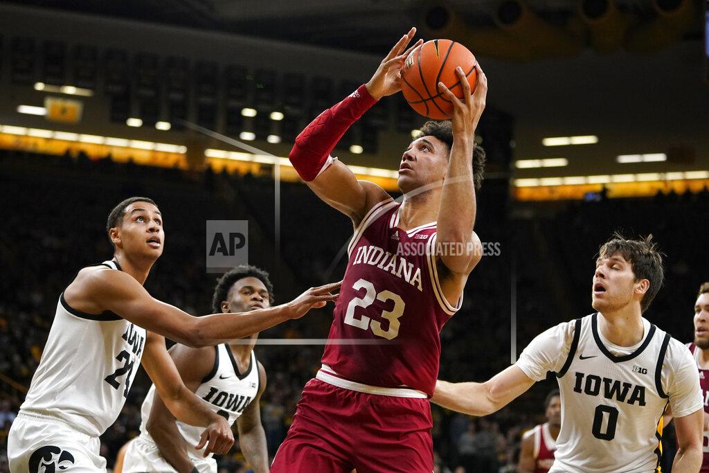 Charlie Neibergall Indiana forward Trayce Jackson-Davis (23) drives to the basket between Iowa forward Kris Murray, left, and forward Filip Rebraca (0) during the first half of an NCAA college basketball game, Thursday, Jan. 13, 2022, in Iowa City, Iowa. (AP Photo/Charlie Neibergall)