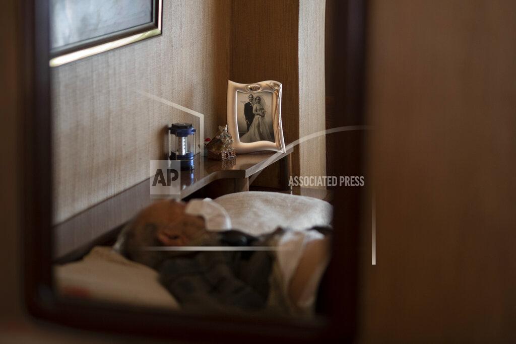 Emilio Morenatti Leopoldo Roman, 85, lies in bed wearing a face mask as he waits for doctors during a home medical visit in Barcelona, Spain, April 3, 2020. Roman, whose leg was amputated years ago, has to pay for daily care out of his pension since the public system only provides for a social worker to come for an hour a day, three days a week. The image was part of a series by Associated Press photographer Emilio Morenatti that won the 2021 Pulitzer Prize for feature photography. (AP Photo/Emilio Morenatti)